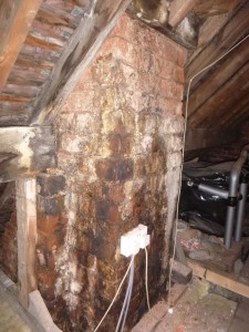 Leaking flues causing staining and salt build up on a chimney stack