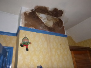 Damp and staining on a chimney breast caused by salts from a flue